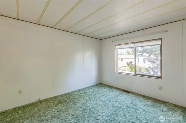 Secondary bedroom located at the opposite end of the home.