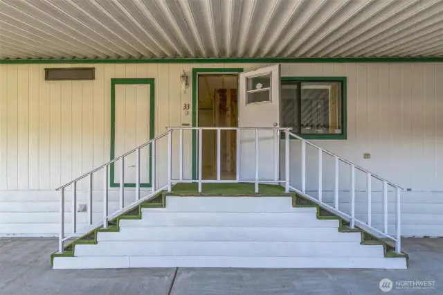 Carport stairs to the back door where you would enter into the laundry/mud room.