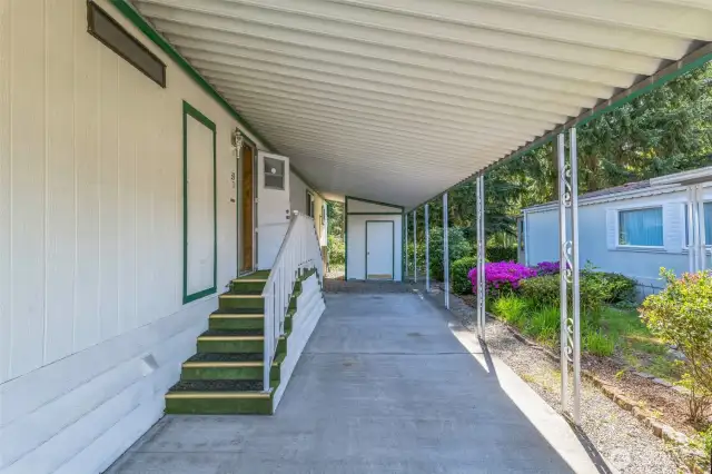 At the end of the carport sits the paint matching secured storage shed.