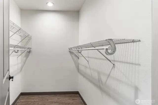 Spacious walk-in primary closet.