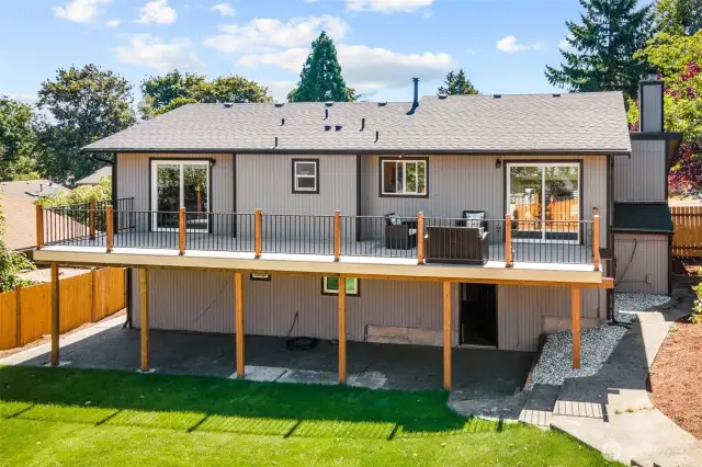 Patio under deck and exterior entrance.