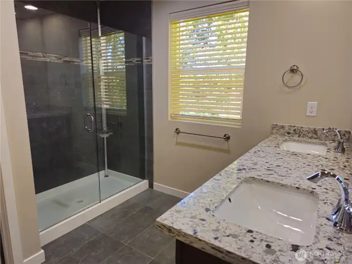 Beautiful en-suite bath with walk-in shower, double sinks, and private bathroom.