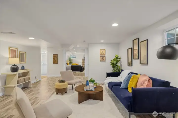Large lower level great room can be used in many ways. Virtually staged here as an additional living room.