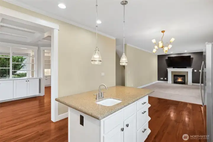 25. Standing here, the layout just clicks. The kitchen island anchors the space, while the sightlines stretch effortlessly into the formal dining room, casual dining spot, and family room. Crown molding ties everything together visually, and the open loop of the floorplan keeps traffic flowing naturally because this is one of those layouts that feels intuitive the first time you walk through, and even better once you’re living in it.