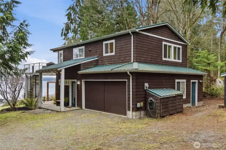 Cedar siding and metal roof make this a a charming waterfront retreat