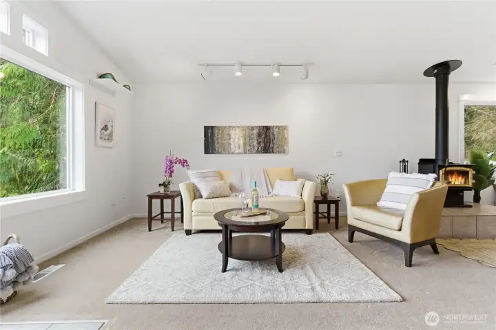 Living Room with an abundance of natural light, and a wood burning free standing wood stove to keep you cozy