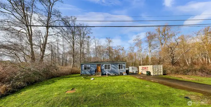 Front yard view with mature trees
