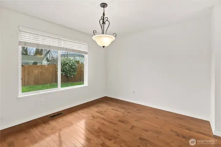 Hardwood floors carry through the dining room, adding warmth and elegance for every gathering.