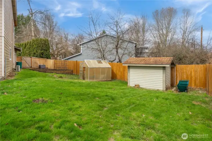 Shed, greenhouse, and garden ready for your personal touch.