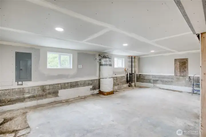 Laundry hookups located in the unfinished basement with room for future customization or utility space.