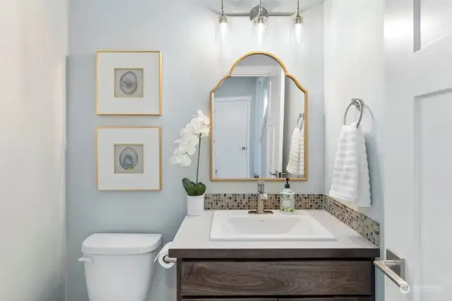 Downstairs powder room offers convenience for guests.