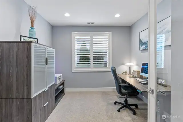 This private office on main with french doors and a window is the perfect space for home office or reading.