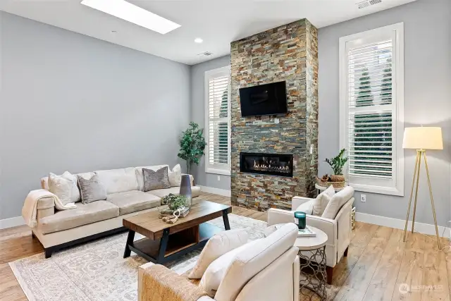 The gas fireplace provides both atmosphere and warmth on cool evenings, and is a real focal point in the living room. Wood shutters on windows on main floor. Skylights offer much needed light needed for grey winter days.