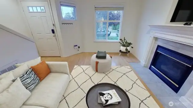 This close in Seattle home has very inviting living area with wood floors and gas fireplace as shown from this recent photo