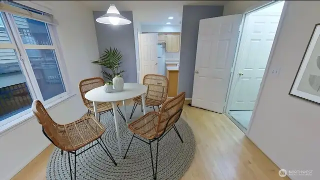 Dining room from earlier staged photo looking towards kitchen.  interior entry from garage to the right