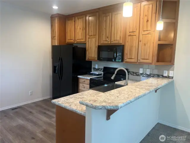 Another view of the kitchen with eating bar.