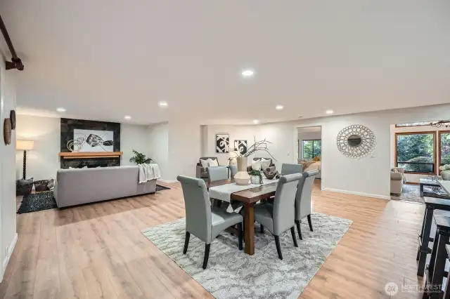 Great room off of the dining area is cozy with its fireplace