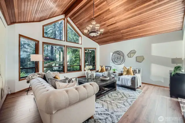 That architectural window and cedar ceilings make this a showcase