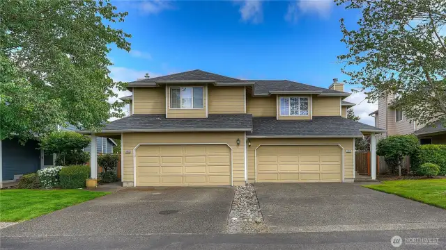 A pitched composition roof and clean gabled rooflines give it a modern suburban aesthetic.