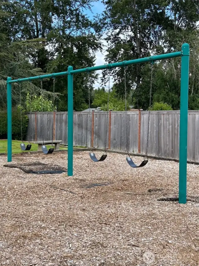 The play area is tucked behind a couple of homes with a path leading to the spot.