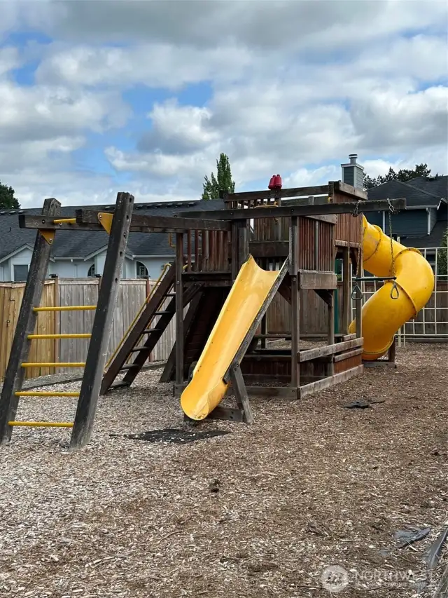 A large play structure~often referred to as a "Big Toy"~features slides, climbing elements, ladders and platforms.  It's designed for a range of ages.