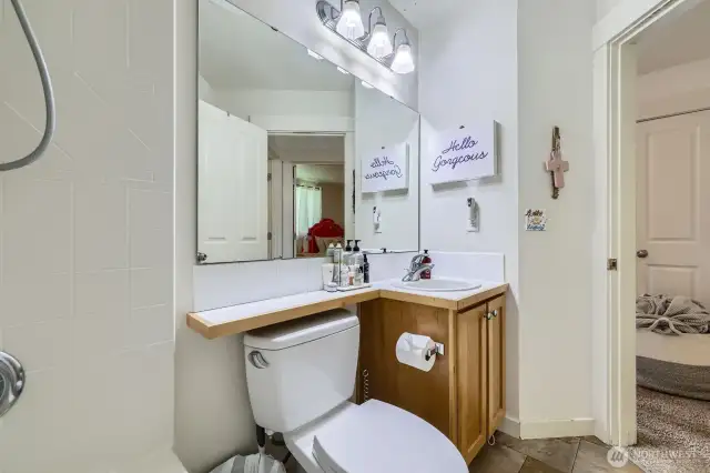 Oversized mirror and tile look floors.
