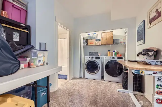 Large laundry area w/additional storage space.