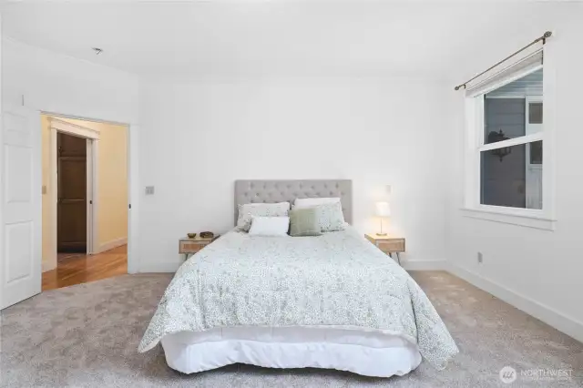 Main level primary bedroom suite.