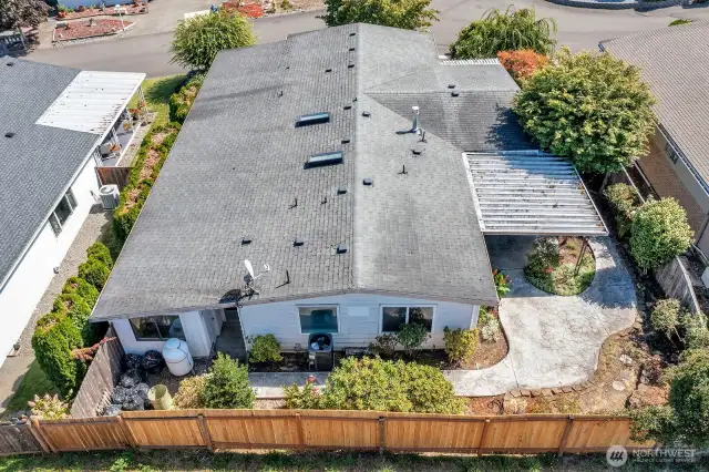 Aerial view of the back of the home. Back and side yards are fenced. Great place for Fido to safely run and play.