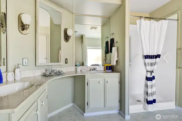 Private 5-piece bath off the primary bedroom. Separate sink and vanities plus a makeup area. Newer step in shower for your convenience.