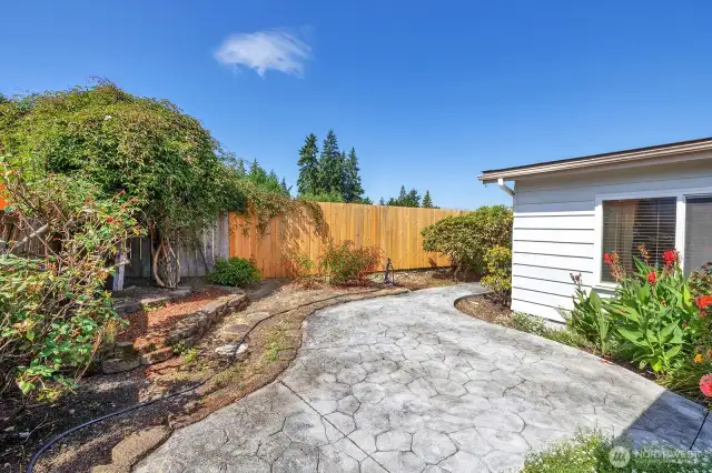 View of the cement sidewalk and easy-care yard.
