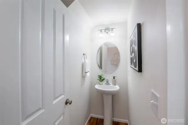 Downstairs Half Bathroom With Pedestal Sink. Toilet Is Behind The Door