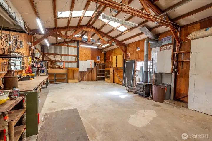 720 sq ft powered detached shop, with wood stove and large electric garage door.