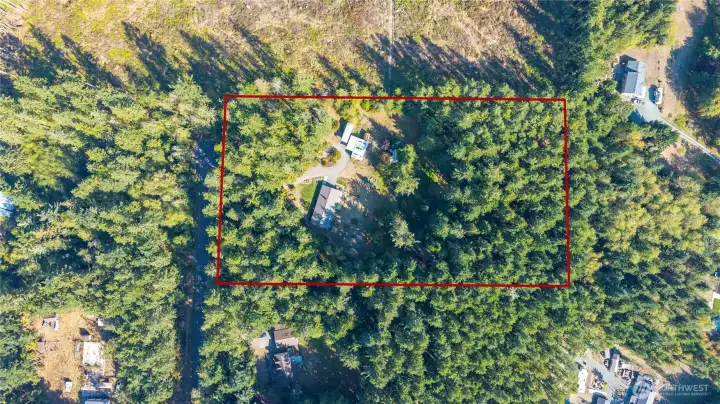 This amazing property is just under 5 acres, gated entryway and fenced. Beautiful forested area which includes commercial grade timber.