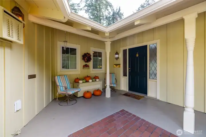 Welcome home.  The deep eaves create the perfect covered "porch" entry area.