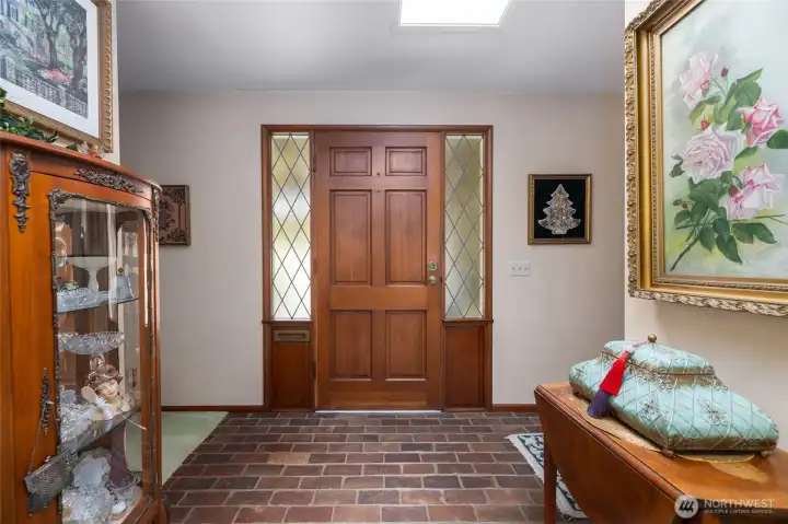 The brick entry and leaded glass sidelights speak to the quality and character of the home.  See the mail slot next to the door?
