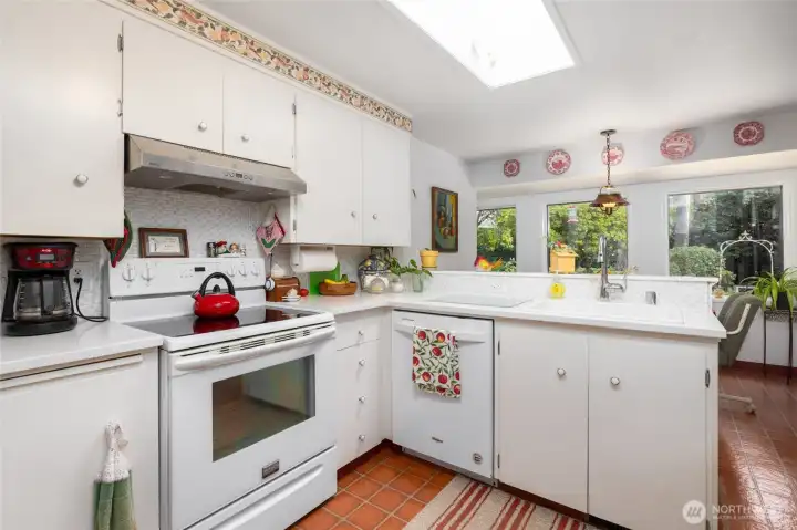 Cute, clean, light, and bright - this kitchen offers modern convenience married to traditional charm (two bread boards!).  A sunny breakfast area adjoins.
