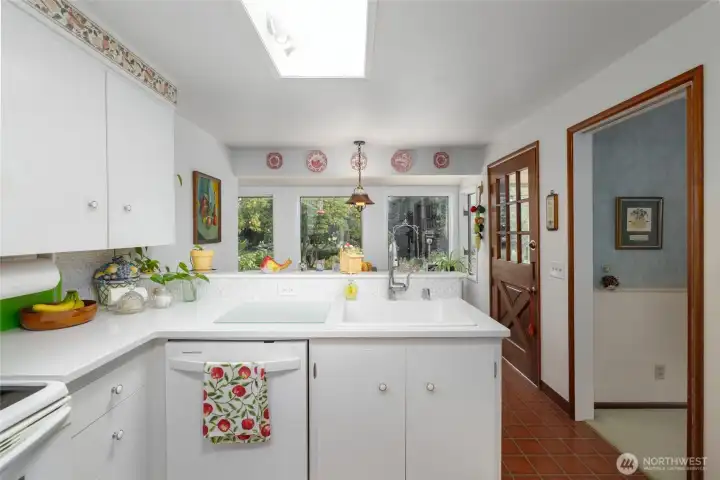 Kitchen, with dining room through the open doorway at right.  Dutch door on right opens to the deck.