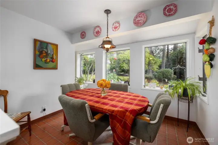 This charming and light-filled breakfast area in the kitchen looks out to the deck and back yard.