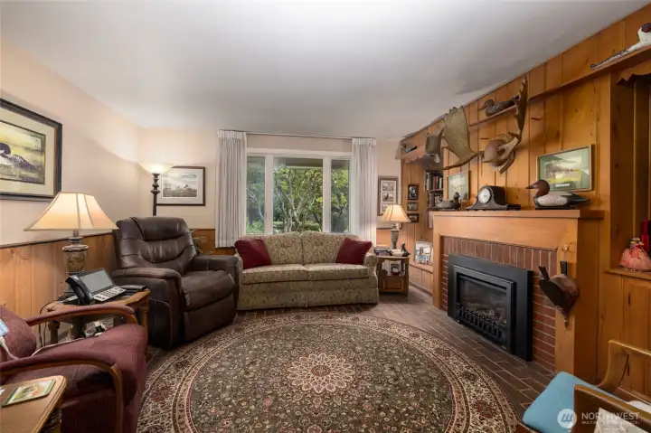 Cozy doesn't do it justice...grab your tea and a blanket and settle in.  The brick floor and knotty pine wall underscore the casual comfort of the den/family room.
