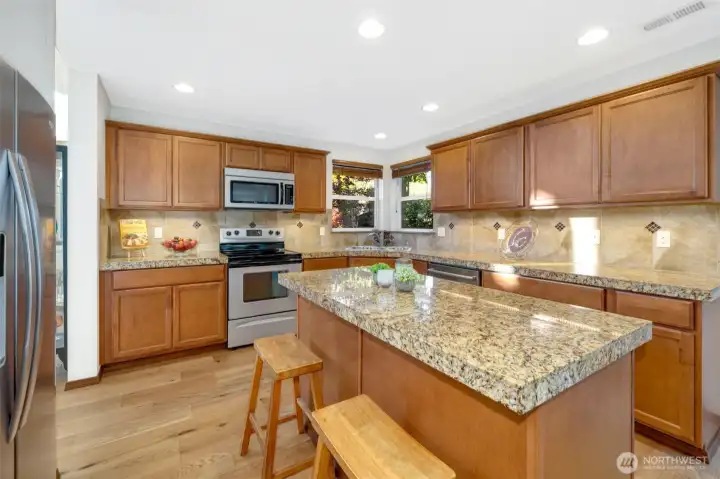 Designed for those who love to cook and connect — granite counters, generous workspace, and room for everyone to gather.