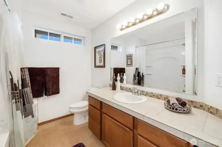 A well-appointed hall bath with a spacious vanity