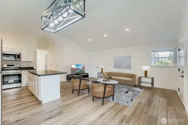 Virtually staged. Enter your new home with all fresh clean walls and surfaces to customize to your desire. Luxury Vinyl Plank (LVP) flooring throughout this home makes it a seamless transition to each room. Convenient canned lights, modern candelier and vaulted ceilings make this space feel larger! Far door leads to the garage and backyard.