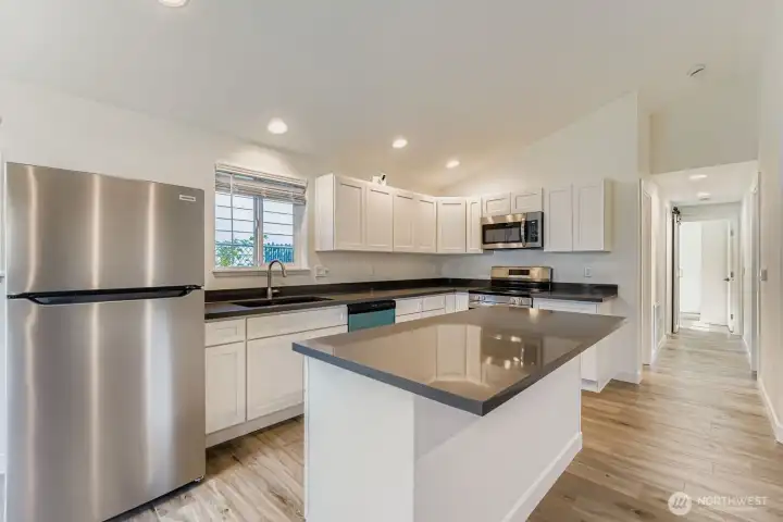 Island has storage on one side and an eating counter on the other.