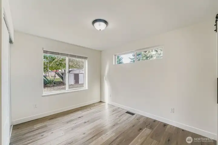Primary bedroom with window facing the backyard.