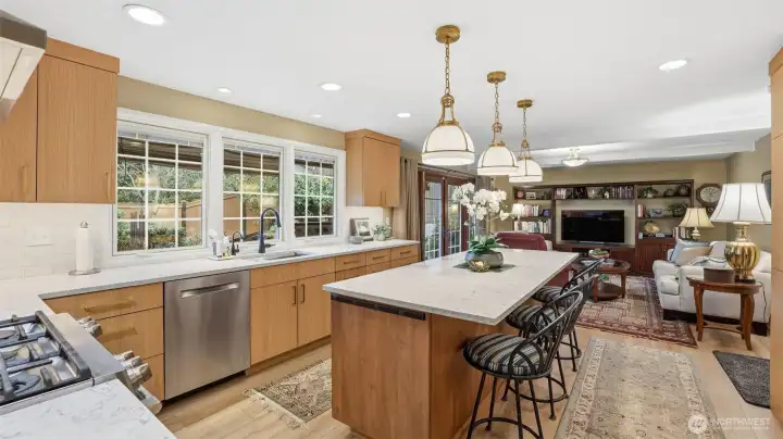 Chef’s kitchen featuring custom cabinetry, upgraded lighting, and generous prep space.
