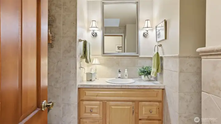 Enjoy your own private ensuite with warm finishes and calming light.