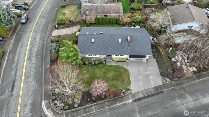 Bird’s-eye view showcasing prime corner-lot location & mature landscaping.