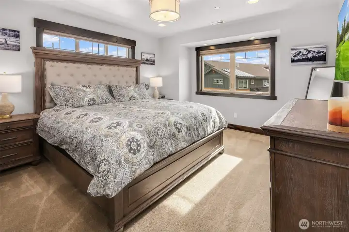 Primary bedroom with King bed, ceiling fan,TV walk in closet and ensuite bath.
