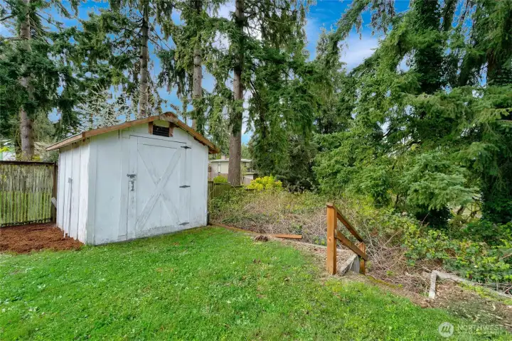 Shed. The property goes down the stairs - room for a playset or garden space!